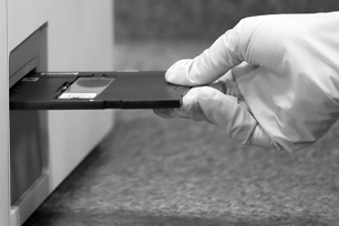 A person inserting a slide into the Digital Cytology machine.