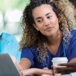 Young female veterinarian watching webinar with a friend