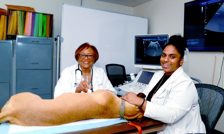 Dr. Carter and student at Tuskegee University College of Veterinary Medicine