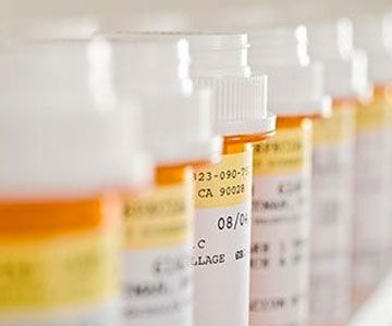 row of medicine bottles with labels
