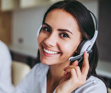 Female Cornerstone Specialist from IDEXX speaking on phone with a customer.