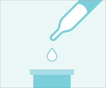 Pipette dropping liquid into beaker