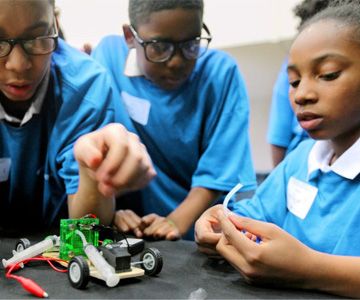 Children work on a robotics project.