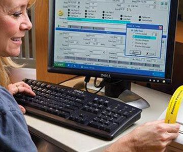 a vet technician prints a PetDetect Pet ID Collar