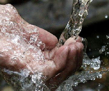 Water pouring into a cupped hand